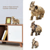 Golden Feng Shui elephant statue for wealth and good fortune displayed on a wooden shelf.