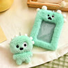 A light green fluffy plush keychain shaped like a small creature with a clear plastic holder for photos