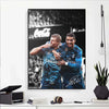 A black and white canvas wall art featuring a portrait of two soccer players celebrating.