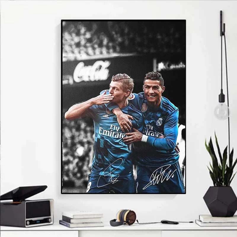 A black and white canvas wall art featuring a portrait of two soccer players celebrating on a field.