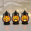 Three decorative black lanterns shaped like pumpkins with glowing orange LED faces