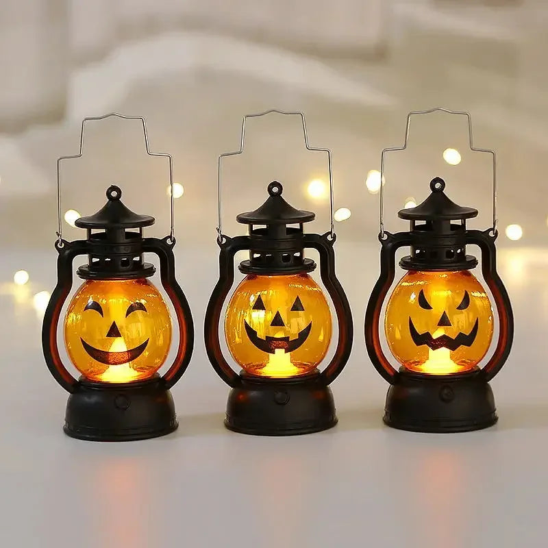 Three decorative black lanterns shaped like pumpkins with glowing orange LED faces
