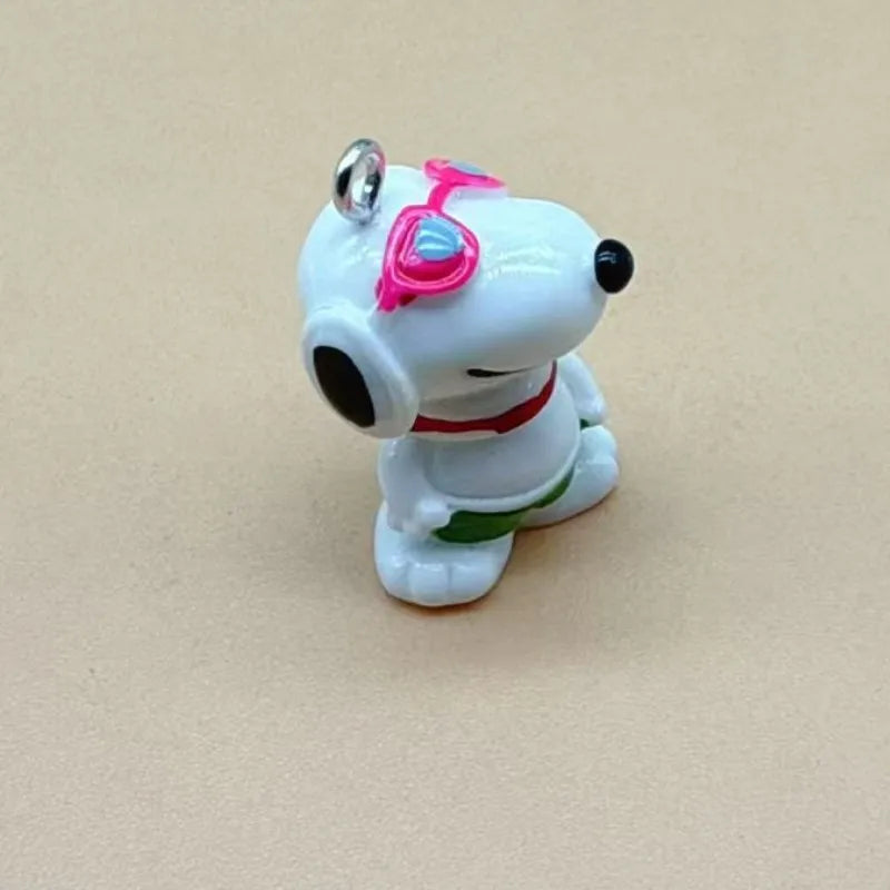 A white ceramic dog pendant with pink accents and a red collar, designed for jewelry making.