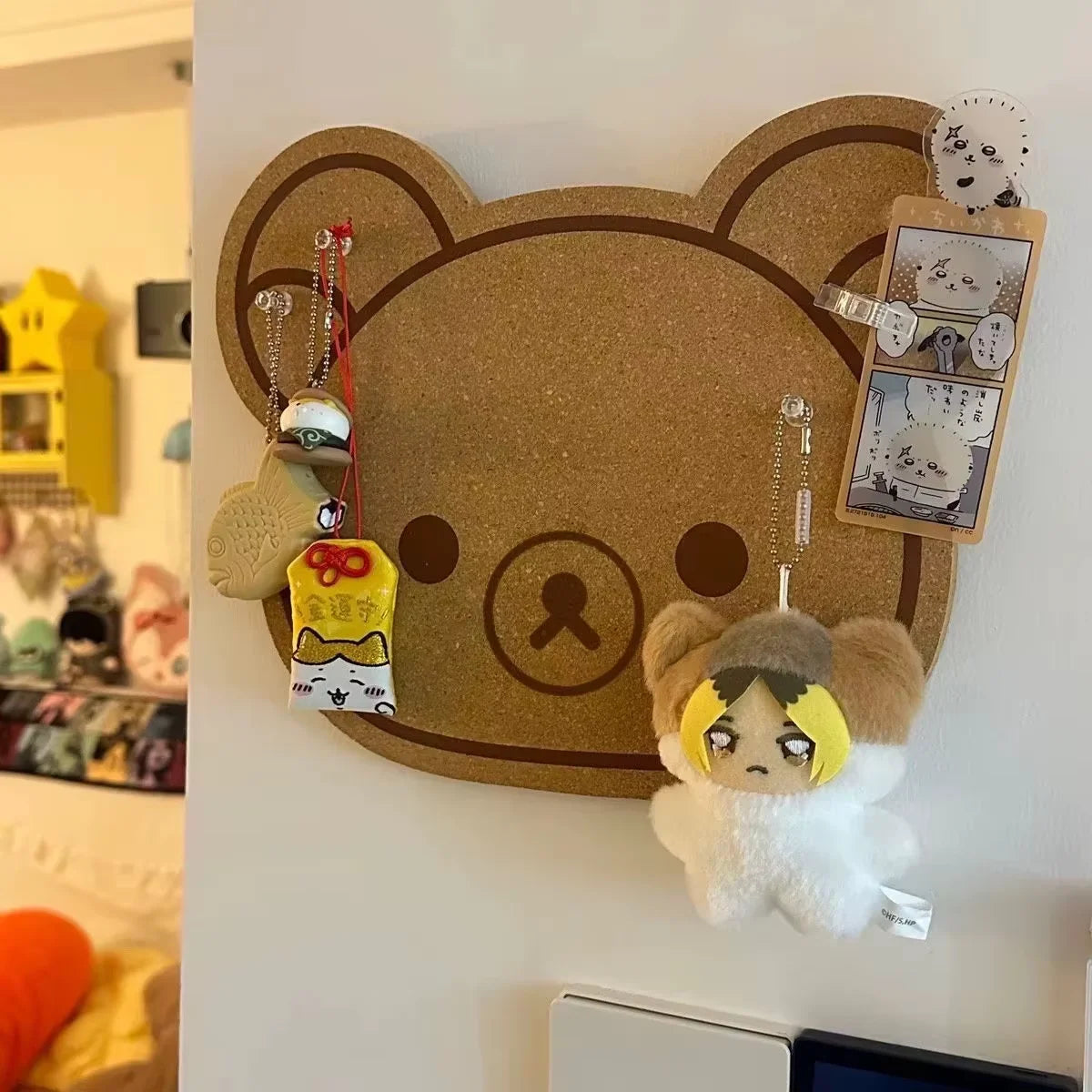 A felt wall decor panel shaped like a brown bear face with large ears, featuring small felt animal figures and decorative ele