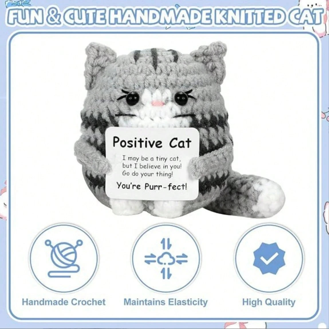 A handmade crochet gray and white striped cat plush toy with a smiling expression.