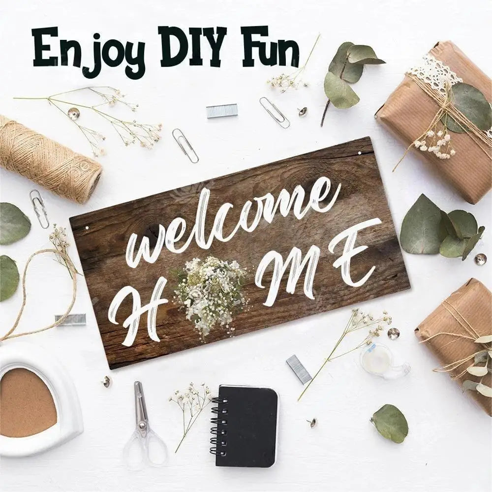 A wooden sign with the text welcome home is displayed on a white background surrounded by crafting tools and greenery.