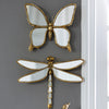 An artisan butterfly wall mirror featuring a gold antique frame and reflective wings.