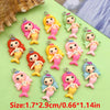 A collection of colorful resin mermaid princess charms in various shades of pink, yellow, and green for jewelry making