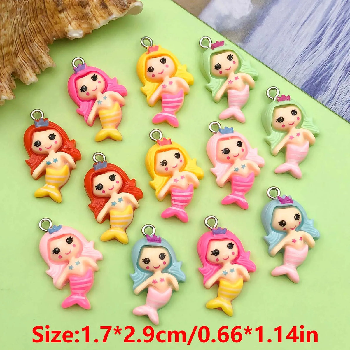 A collection of colorful resin mermaid princess charms in various shades of pink, yellow, and green for jewelry making