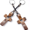 A wooden comfort prayer cross with silver rings and black cord for anxiety relief.