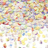 A close-up of iridescent sea shell PVC sequins in various pastel colors scattered on a white background.