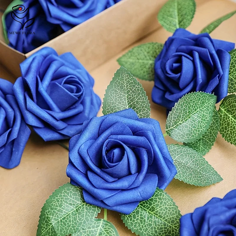 A close-up of three deep blue artificial roses with green leaves arranged in a cardboard box.