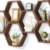 A set of four hexagonal wooden floating shelves displaying decorative items like a clock, sailboat, windmill, and globe.