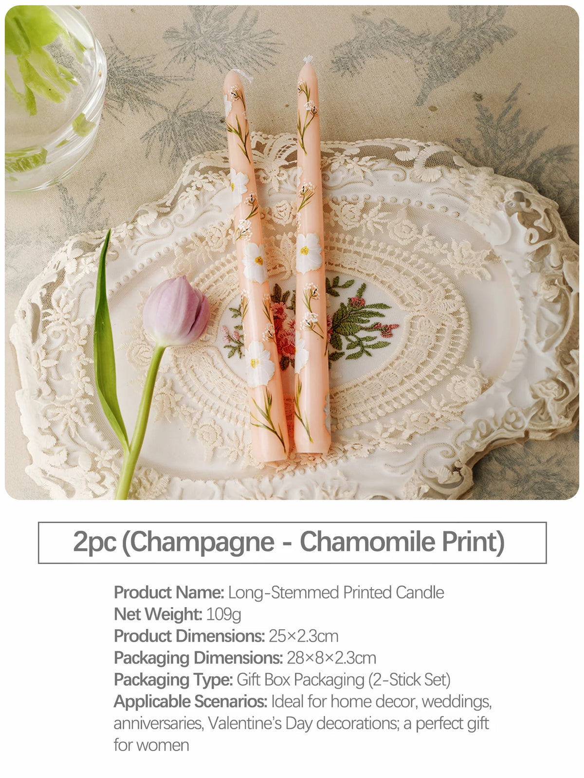 Two long-stemmed printed candles in peach and white with floral designs displayed on a lace platter.