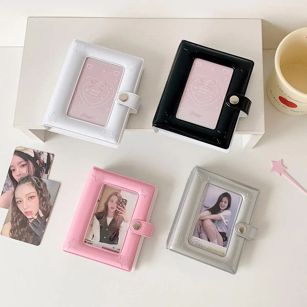 A collection of pink and silver photo card holders in various frames and holders arranged on a white surface.