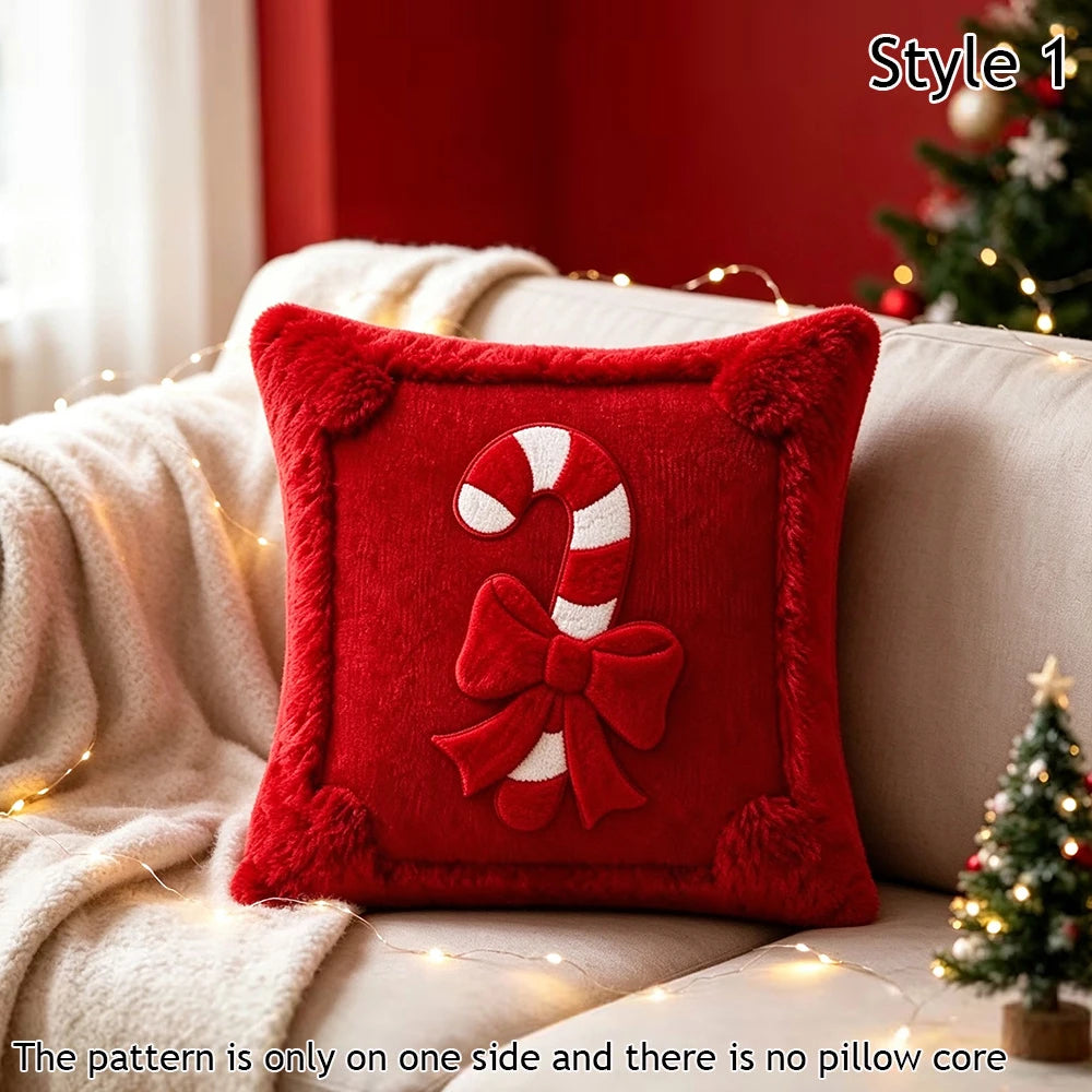 A red velvet pillow cover featuring a white candy cane bow design on one side, displayed on a sofa with holiday lights.