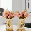 A pair of elegant ceramic swan vases with gold accents used for modern home decor.
