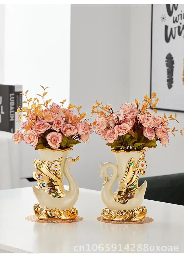 A pair of elegant ceramic swan vases with gold accents used for modern home decor.