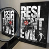 A framed poster featuring a distressed, gritty design with the text RESIDENT EVIL and imagery of a figure.