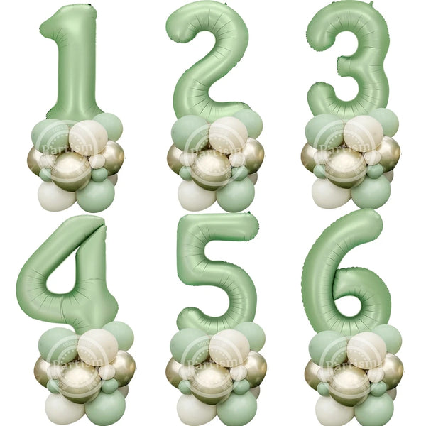 A set of vintage green foil balloons shaped like the numbers 1 through 6 for birthday decor