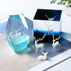 Mini elk deer resin landscape ornament displayed in a clear blue crystal and a dark square box.