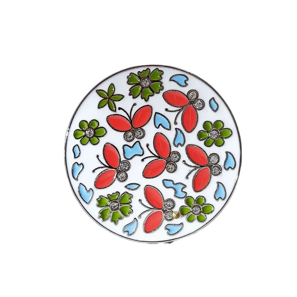 A decorative ceramic plate featuring floral crystal designs in green, red, and blue.
