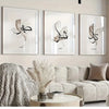 A gallery wall featuring three framed Islamic calligraphy pieces on a light-colored wall above a beige sofa.