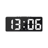 A black digital alarm clock displaying the time 13:06.