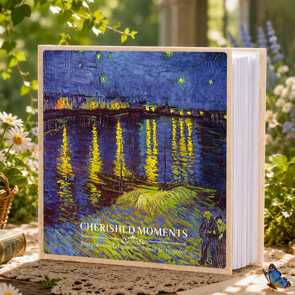 A photo album featuring a painting of reflections on water with yellow and green light against a dark blue sky.