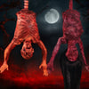 A prop depicting a hanging corpse with blood effects against a dark background and a moon.