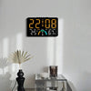 A digital alarm clock displaying 22:08, temperature, and humidity on a white wall.