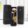 Three black gift boxes with gold foil accents and a pink rose design displayed on a white surface.
