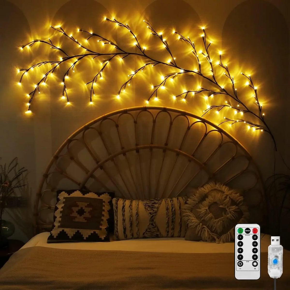 LED vine string lights illuminating a bedroom wall and headboard with a remote control device