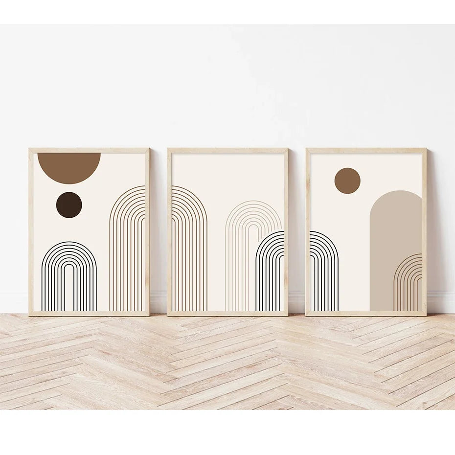 Un set de tres piezas de arte abstracto en lienzo enmarcado con dibujos de líneas minimalistas y formas circulares en tonos n