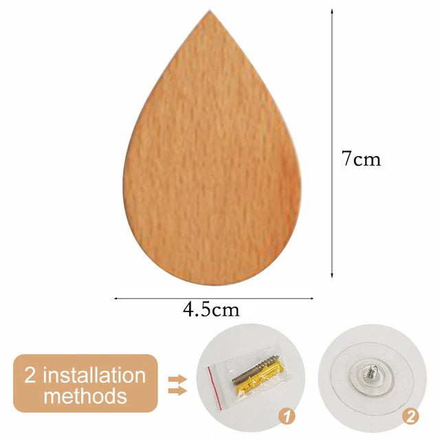 A light wood wooden animal hook with a pointed shape, shown next to installation instructions.