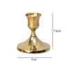 A brass vintage iron candlestick holder with a flared base and cup, shown from the side.