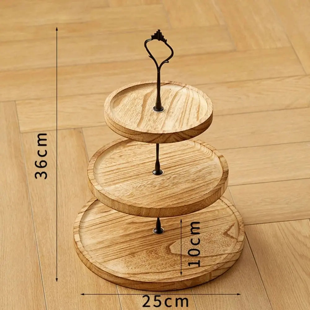 A wooden 3-tier cupcake stand with three circular layers and a wire holder, shown on a light wood floor.