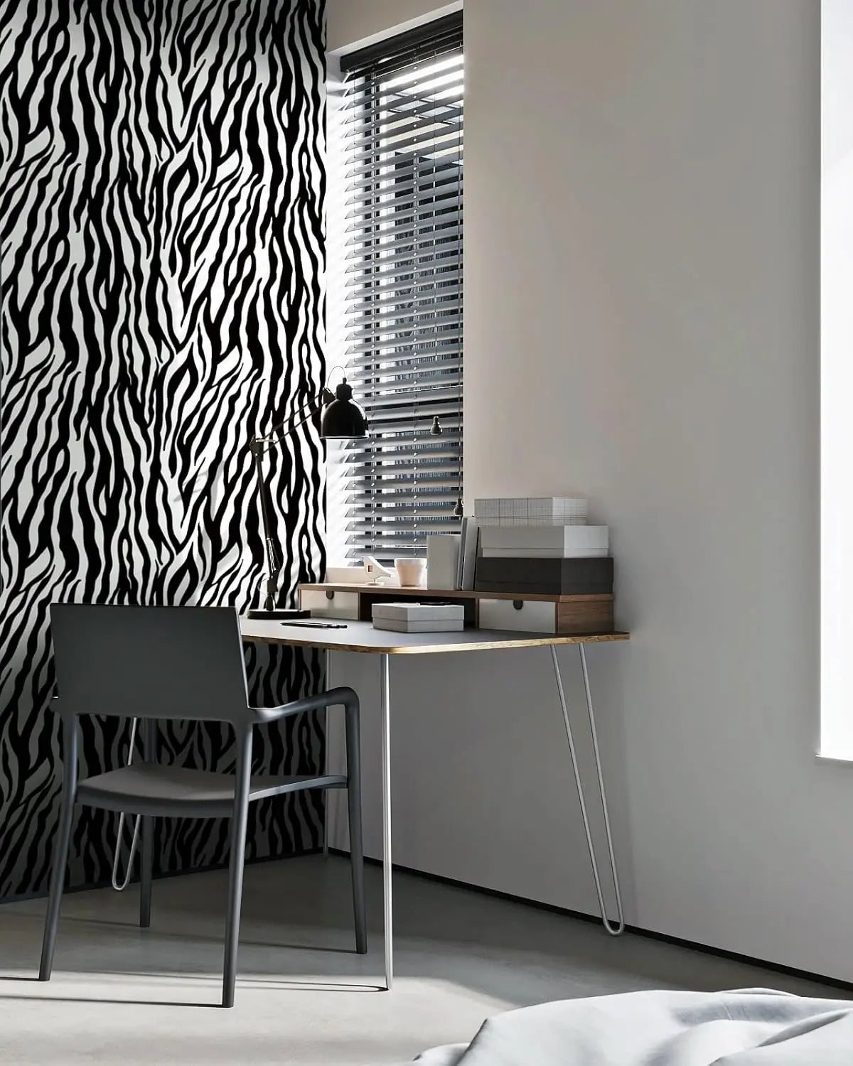 A modern interior featuring a black and white zebra print wall, a desk with a chair, and vertical blinds.
