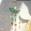 Handcrafted moon crystal suncatcher featuring a crescent moon and prism pendant with green crystals.