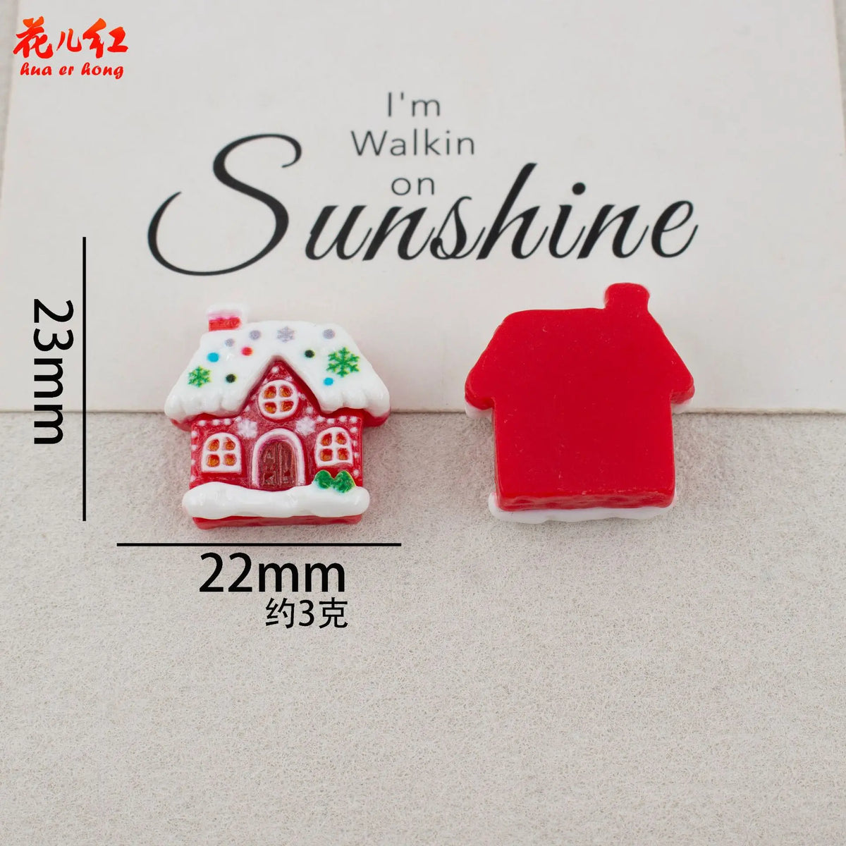 Two small red and white Christmas-themed resin cabochons shaped like houses