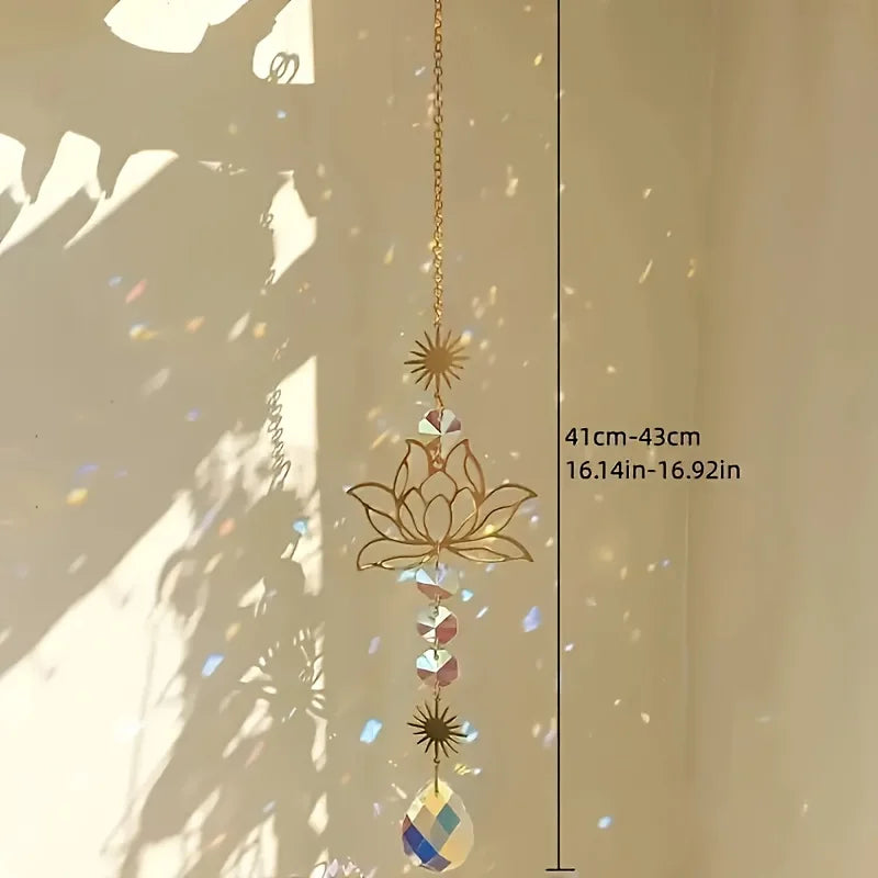 A hanging lotus flower crystal glass suncatcher with prism beads suspended by a gold chain.