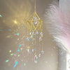 A golden crystal hanging suncatcher decoration with dangling clear and colored glass elements.