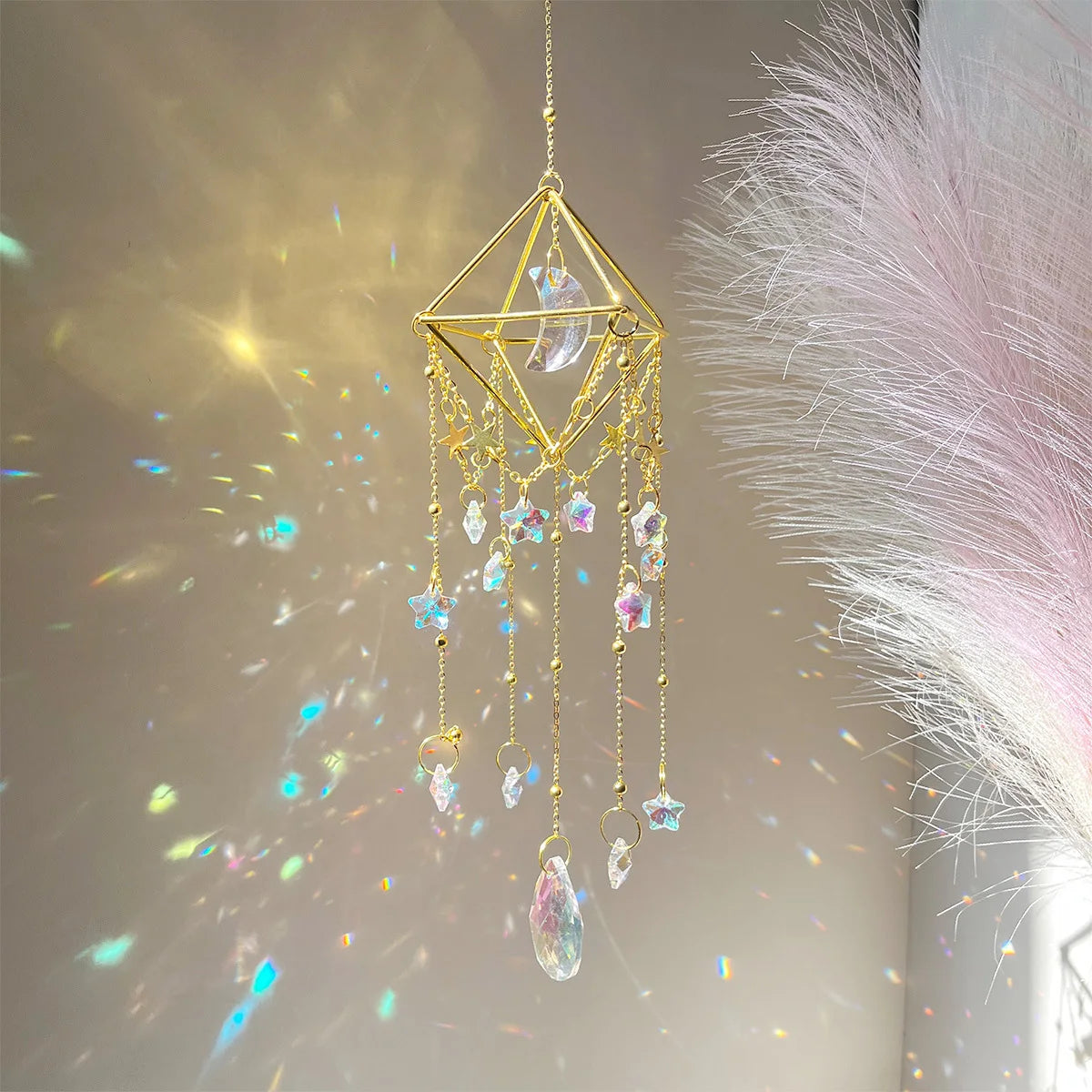 A golden crystal hanging suncatcher decoration with dangling clear and colored glass elements.