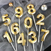 Gold metallic 3D crown number candles spelling out 56821437 for birthday celebrations