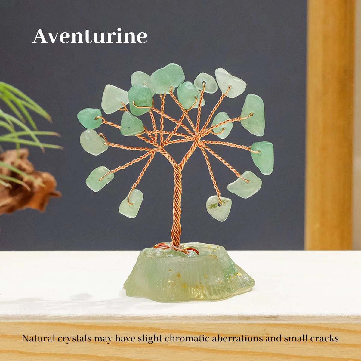 A green Aventurine crystal tree featuring small, translucent green stones branching out from a larger base.