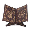 Handcrafted wooden Quran book stand featuring intricate arabesque carvings.