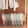 Acrylic cap storage rack displaying several light pink and beige acrylic caps.