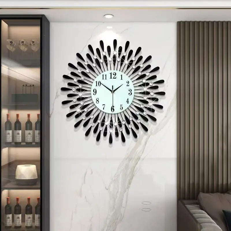 A modern minimalist metal wall clock with a black face and silver accents mounted on a white marble wall.