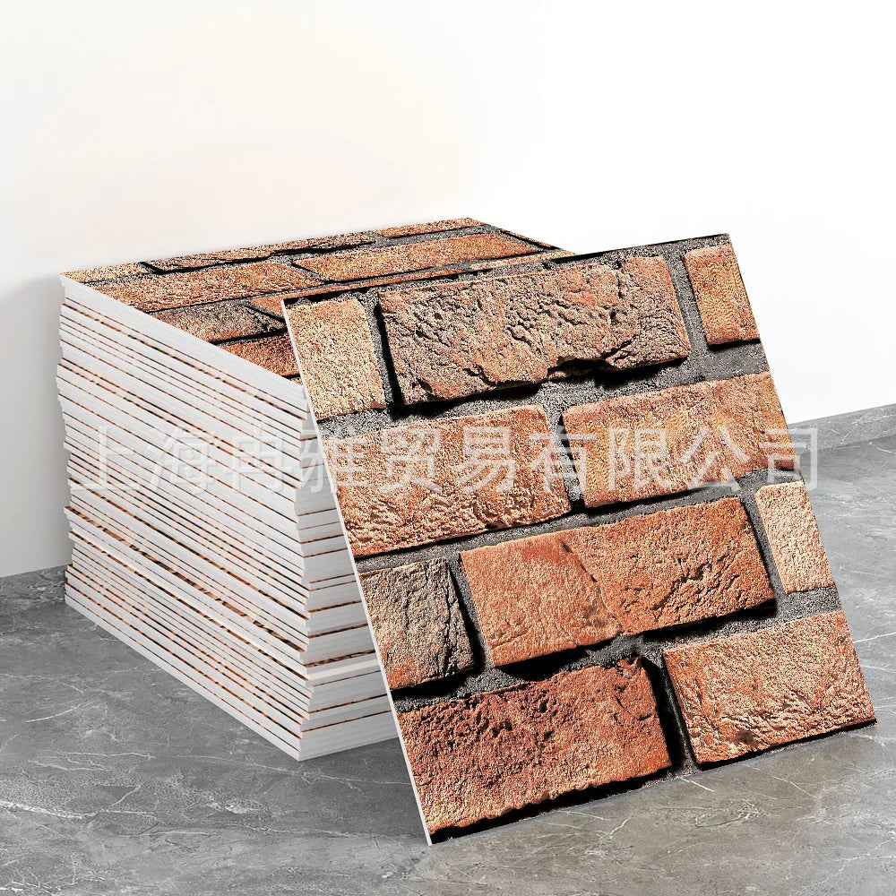 A stack of rectangular marble peel-and-stick tiles with gold accents displayed on a gray surface.