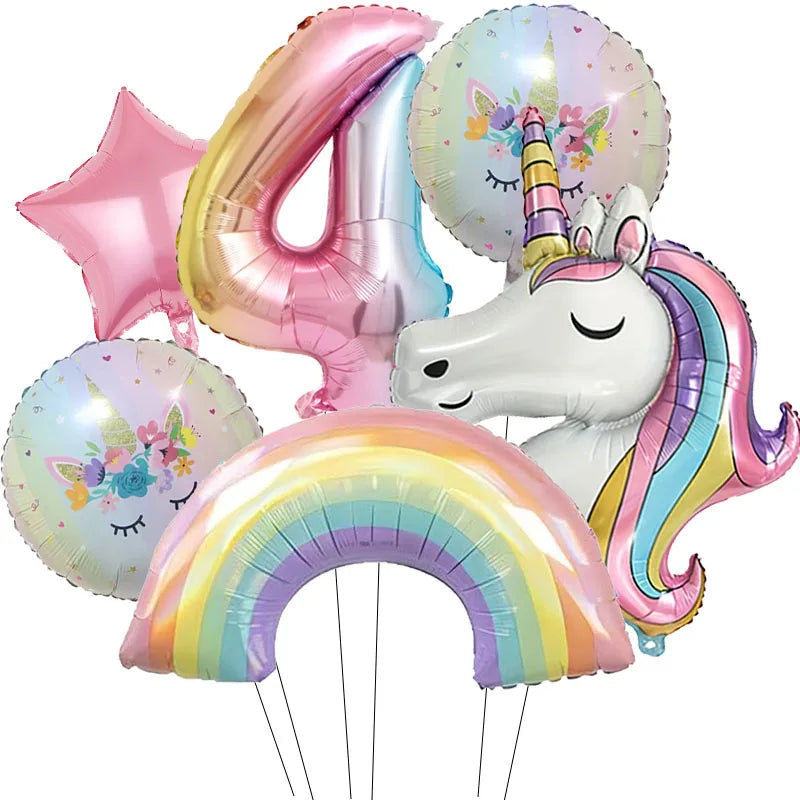 A collection of foil balloons featuring a large number four, a pink star, a unicorn head, and a rainbow arch.